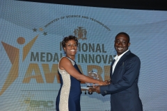 Mr. Mark Bennett,  Enegry and Energy Efficient Category winner receives award from Miss Ava Tomlin,Regional Director, BMR Jamaica Wind Energy Ltd.