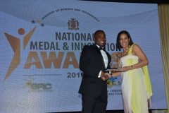 Ms Kelly Silvera, accepts award on behalf of Interactive Toucan Jamaica Ltd, in the Environmental Sustainability category from Mr Marvin Campbell, Director, Regional Operations (East), Jamaica Public Service (JPSco).