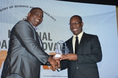 Mr. Lidon Falconer,  Engineeering & Manufacturing Category winner receives award from Dr Cliff Riley, Executive Director, Scientific Research Council.