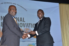 Mr.  Jordan Freeman,  Youth Invention Category winner receives award from Mr  Trevor Forrest  Deputy Board Chairman, Universal Service Fund.