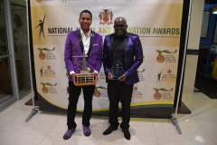 Mr Chritopher Dhering and Mr Gaunlet Cassonova  smile for the cameras with trophy won at  2018 National Innovation Awards  Ceremony